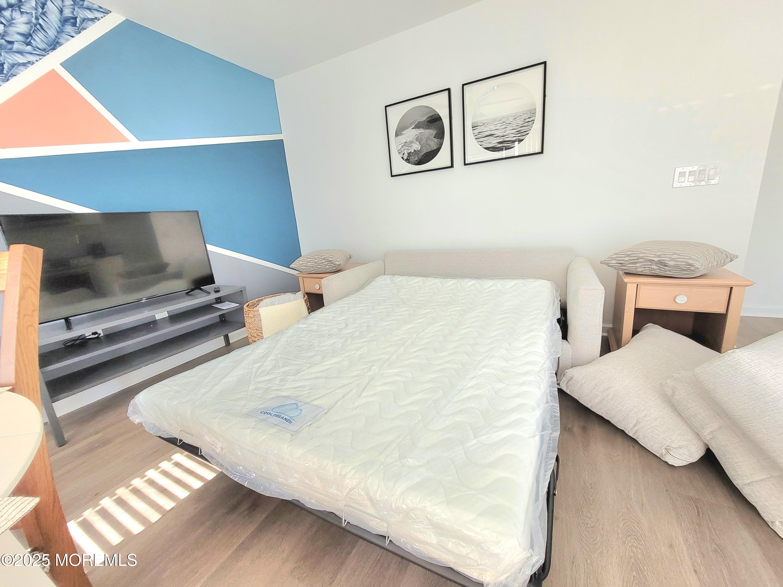 1134 Springwood Avenue, Unit B Asbury Park, NJ 07712 - Photo 8 of 19 a bedroom with a bed and tv