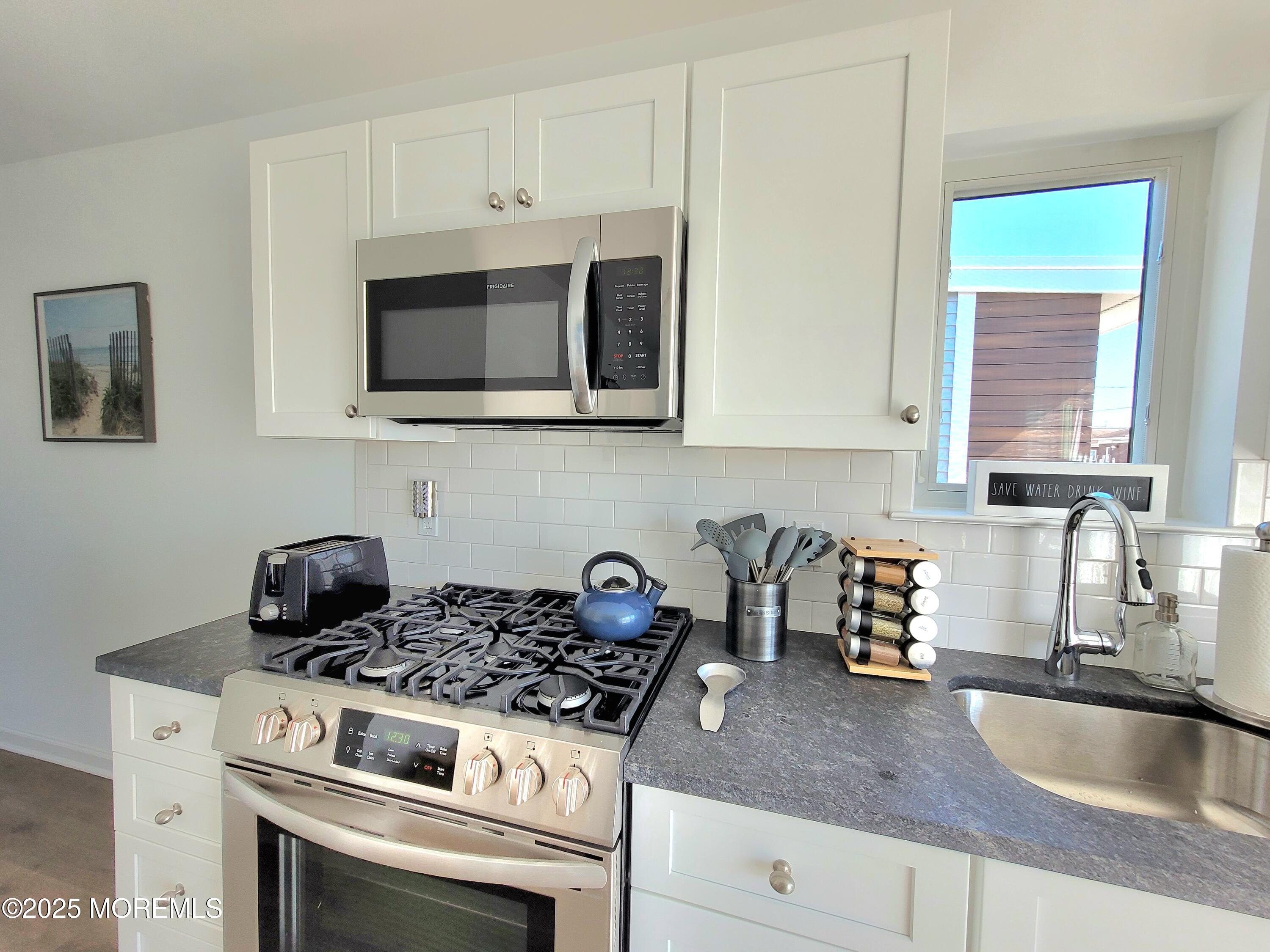 1134 Springwood Avenue, Unit B Asbury Park, NJ 07712 - Photo 10 of 19 a kitchen with granite countertop a stove and a sink