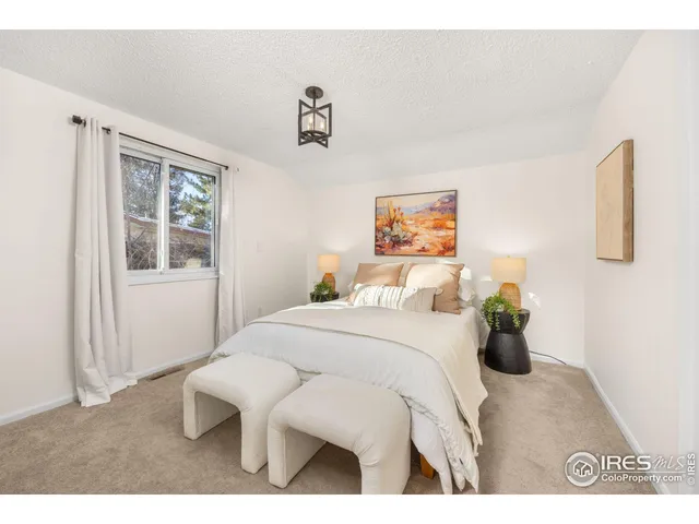 a bedroom with a bed and glass windows