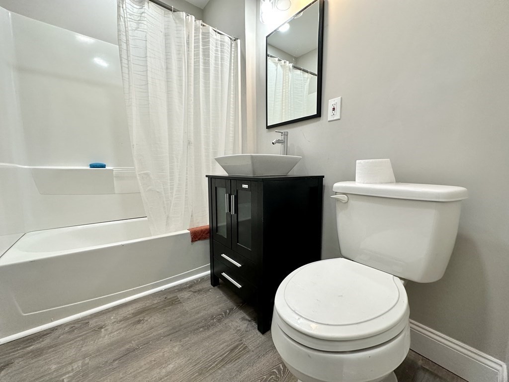 38-40 Pasadena Street Springfield, MA 01108 - Photo 32 of 37 a bathroom with a toilet a sink and bathtub