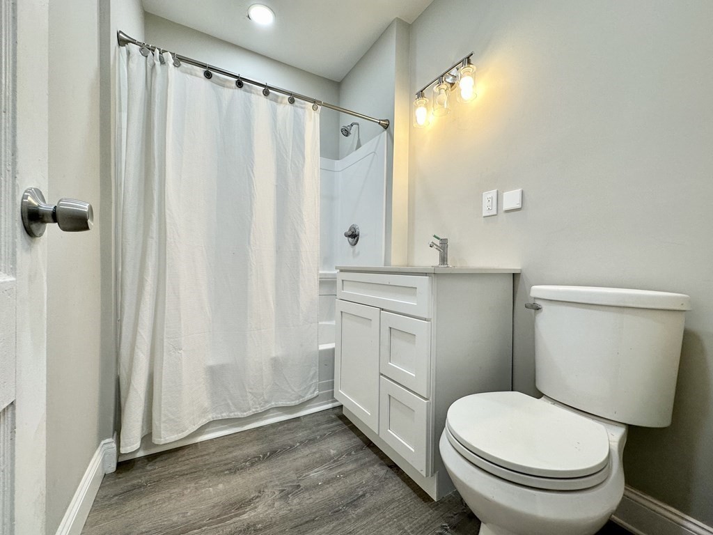 38-40 Pasadena Street Springfield, MA 01108 - Photo 5 of 37 a bathroom with a sink a toilet a mirror and shower