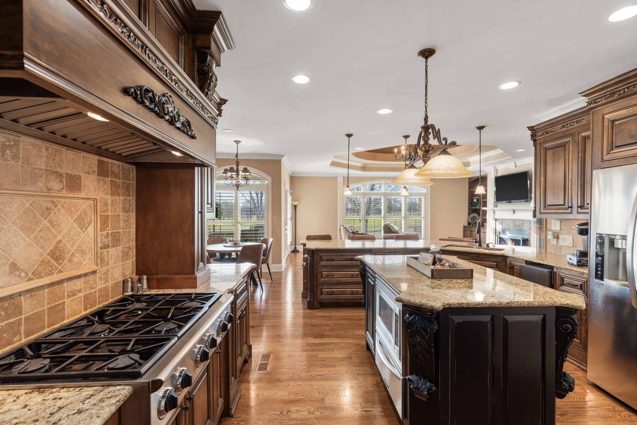 763 Plantation Way Gallatin, TN 37066 - Photo 13 of 65 a kitchen with kitchen island a stove a sink a counter space wooden floor and stainless steel appliances