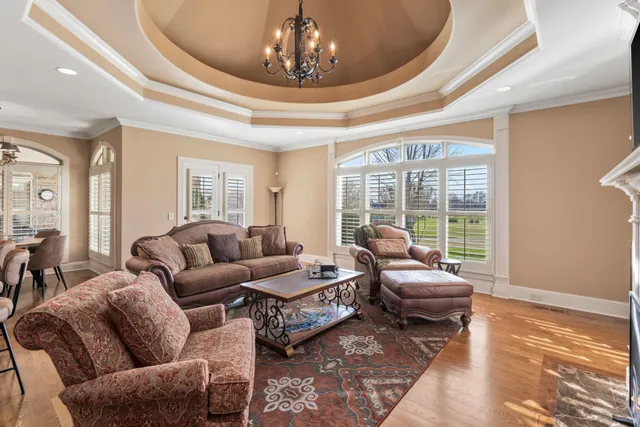a living room with furniture a fireplace and a large window