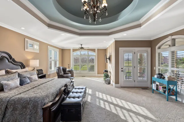 a spacious bathroom with a tub a double vanity sink a mirror a shower and a large window