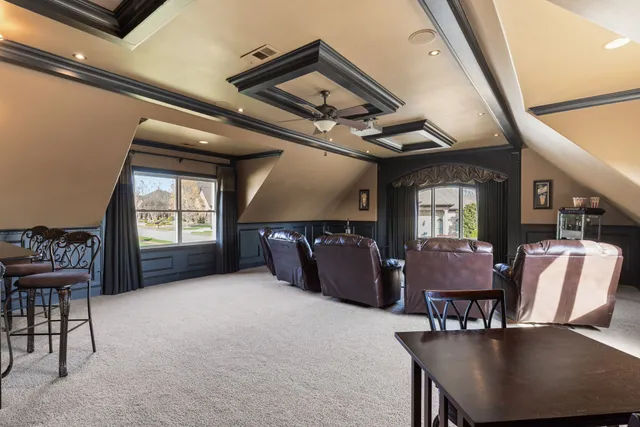 a view of a dining room with furniture large windows and wooden floor