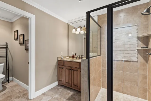 a view of swimming pool with seating space and trees in the background