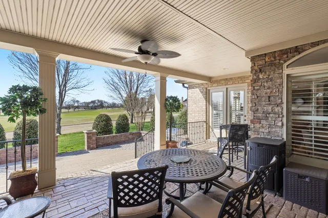 an aerial view of a house with garden space and car parked