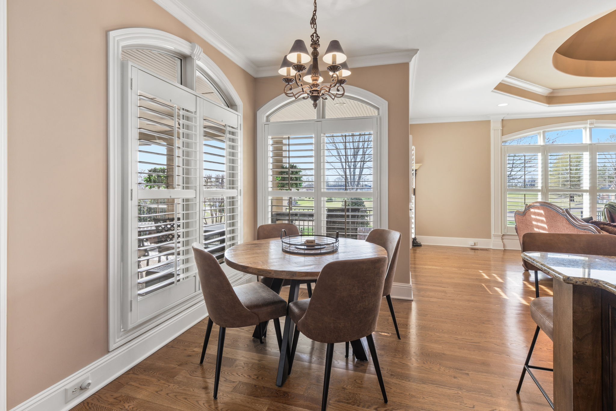 763 Plantation Way Gallatin, TN 37066 - Photo 9 of 65 a dining room with wooden floor a chandelier a wooden table and chairs