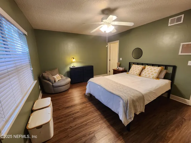 a bedroom with a bed couch and window