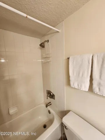 a bathroom with a bathtub and a toilet
