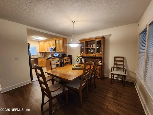a view of a dining room with furniture window and wooden floor