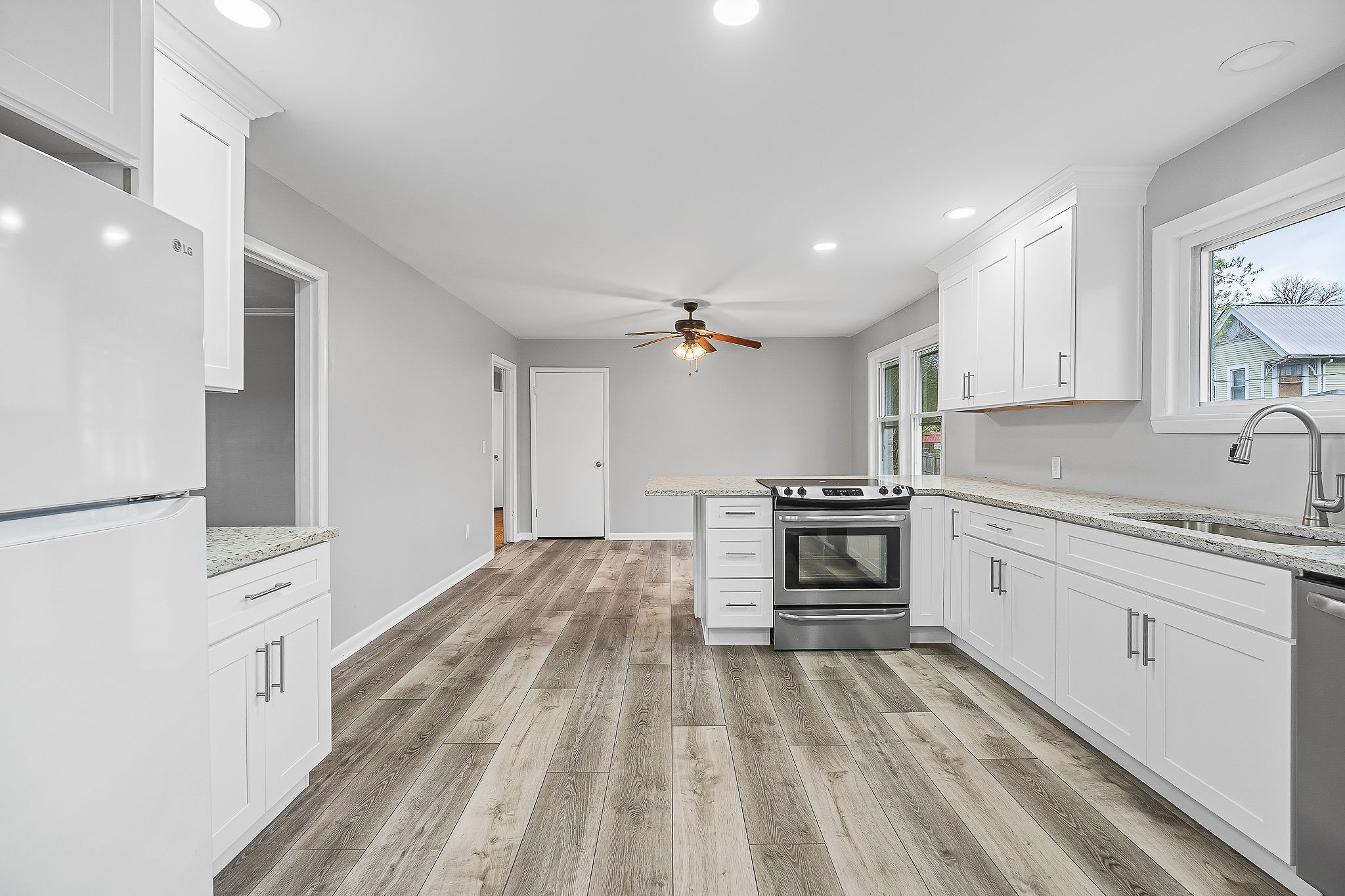 106 North Main Street Sparta, TN 38583 - Photo 12 of 28 a kitchen with granite countertop a stove top oven and sink
