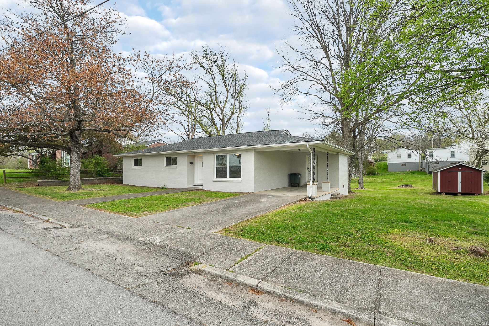 106 North Main Street Sparta, TN 38583 - Photo 2 of 28 a view of a yard in front of a house with large trees