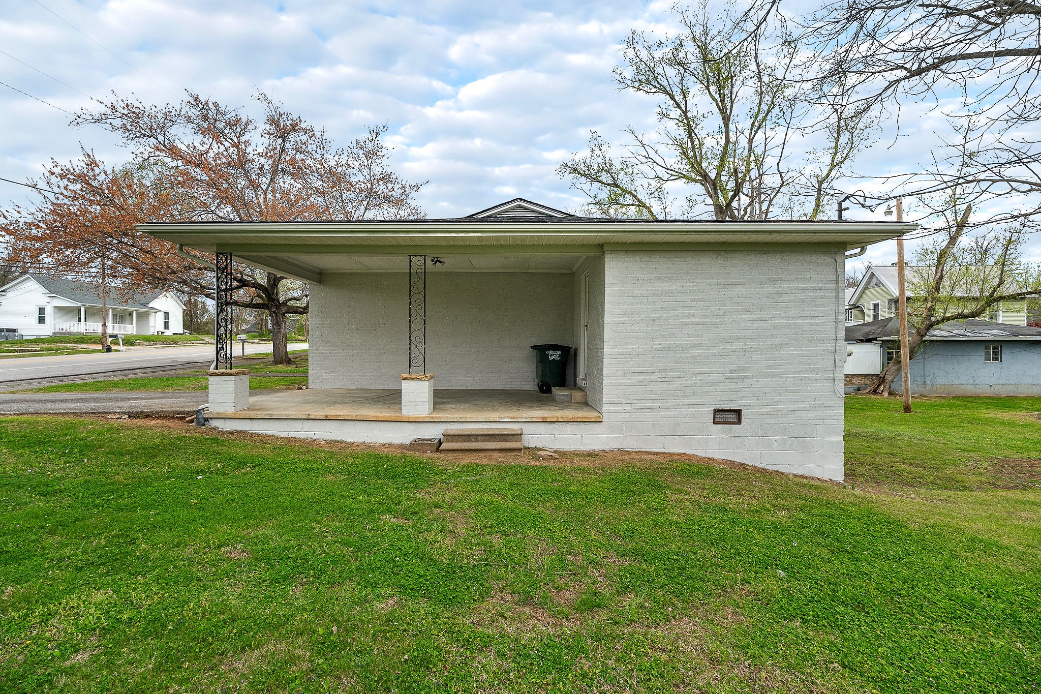 106 North Main Street Sparta, TN 38583 - Photo 24 of 28 a view of a wooden house with a big yard and large trees