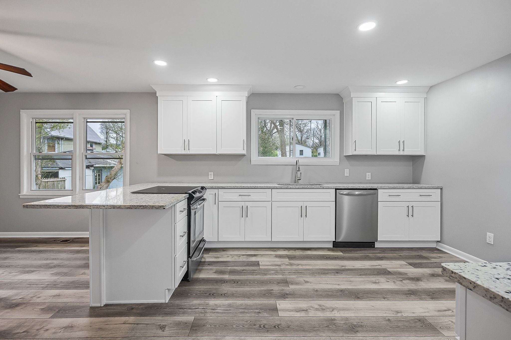 106 North Main Street Sparta, TN 38583 - Photo 8 of 28 a kitchen with granite countertop white cabinets and window