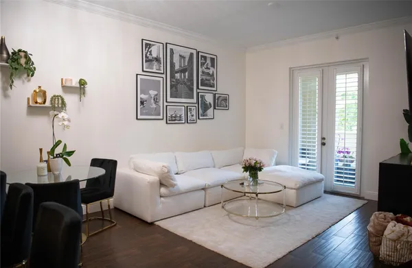 a living room with furniture potted plant and window
