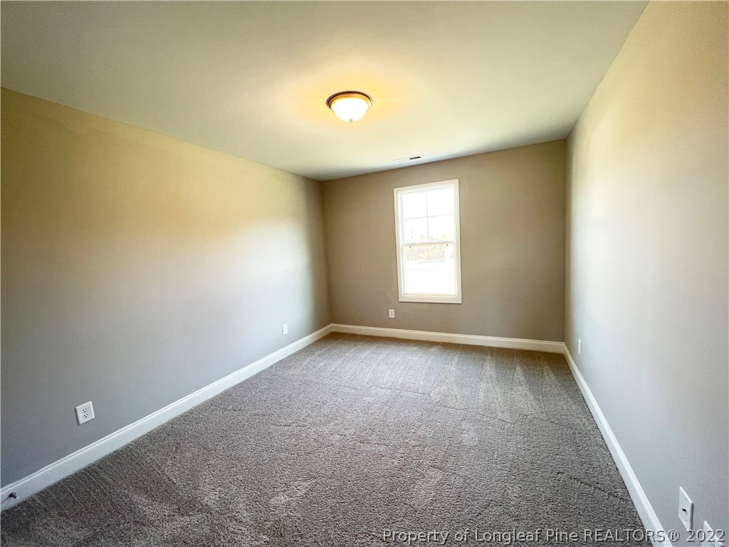 7810 Rufus Johnson Road St. Pauls, NC 28384 - Photo 11 of 18 an empty room with a window