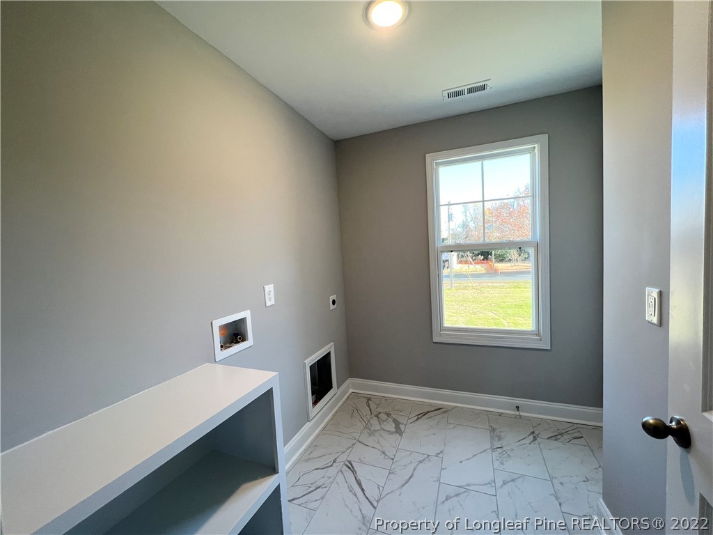 7810 Rufus Johnson Road St. Pauls, NC 28384 - Photo 12 of 18 a view of room with window and hardwood floor