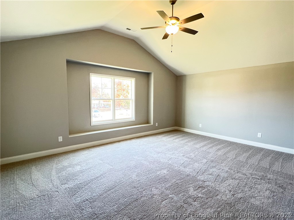 7810 Rufus Johnson Road St. Pauls, NC 28384 - Photo 13 of 18 an empty room with windows and fan