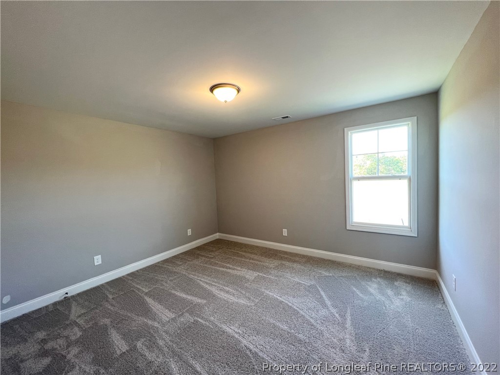 7810 Rufus Johnson Road St. Pauls, NC 28384 - Photo 8 of 18 an empty room with a window