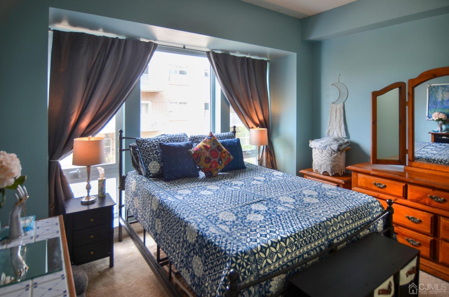 358 Rector Street, Unit 304 Perth Amboy, NJ 08861 - Photo 13 of 28 a bedroom with a bed and wooden floor
