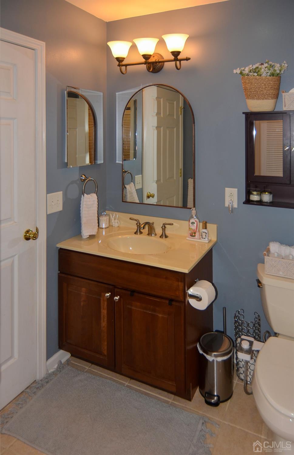 358 Rector Street, Unit 304 Perth Amboy, NJ 08861 - Photo 18 of 28 a bathroom with a toilet sink and mirror