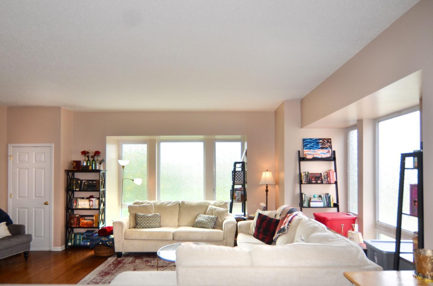 358 Rector Street, Unit 304 Perth Amboy, NJ 08861 - Photo 2 of 28 a living room with furniture and a book shelf