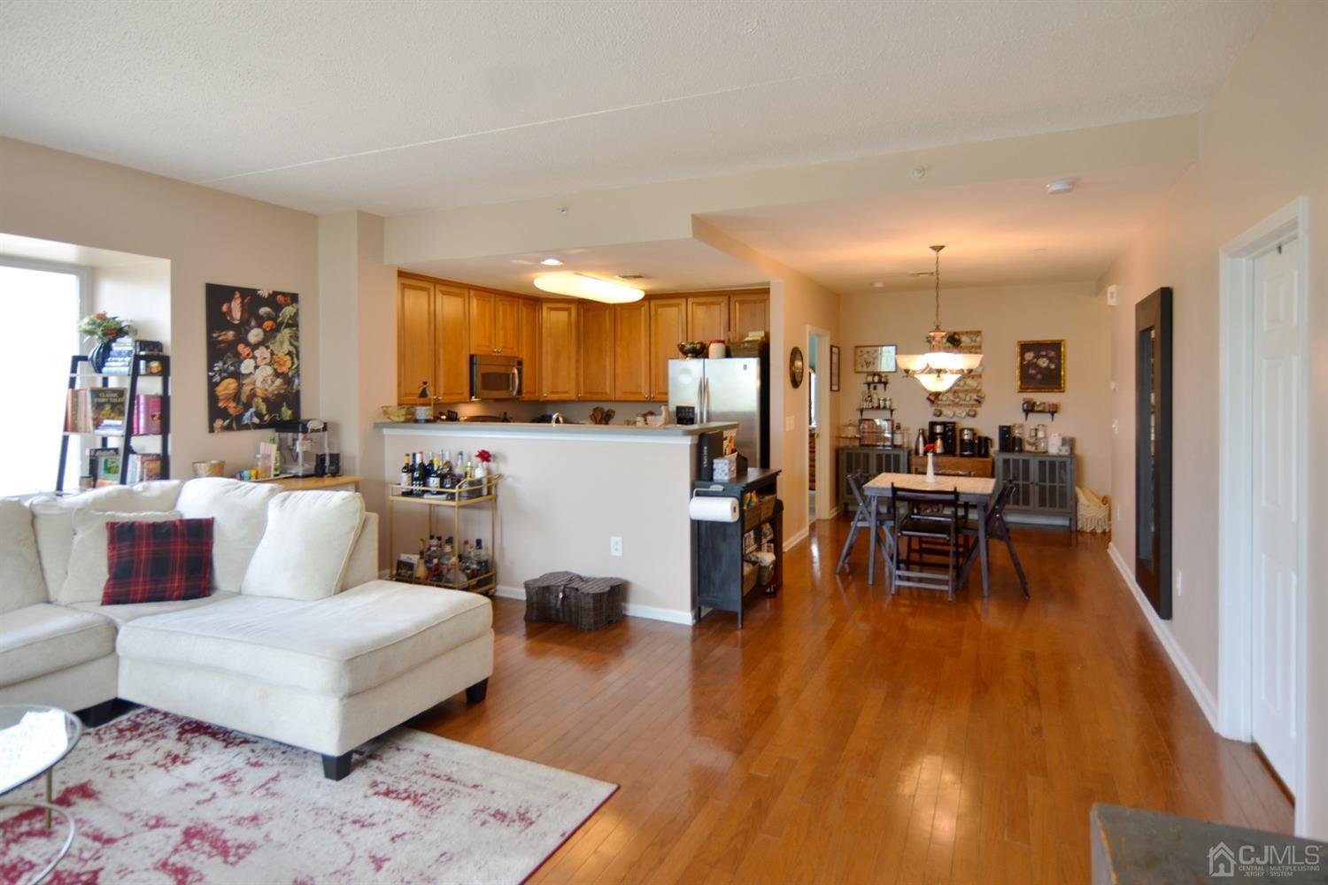 358 Rector Street, Unit 304 Perth Amboy, NJ 08861 - Photo 3 of 28 a living room with furniture and a wooden floor