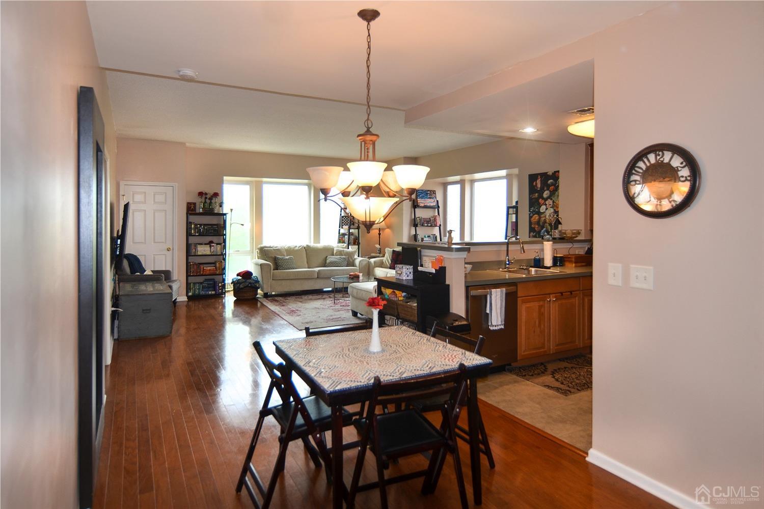 358 Rector Street, Unit 304 Perth Amboy, NJ 08861 - Photo 4 of 28 a view of a dining room with furniture window and wooden floor