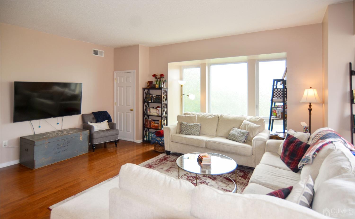 358 Rector Street, Unit 304 Perth Amboy, NJ 08861 - Photo 5 of 28 a living room with furniture and a flat screen tv