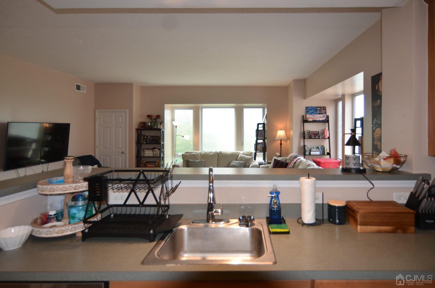 358 Rector Street, Unit 304 Perth Amboy, NJ 08861 - Photo 8 of 28 a living room with furniture and a flat screen tv