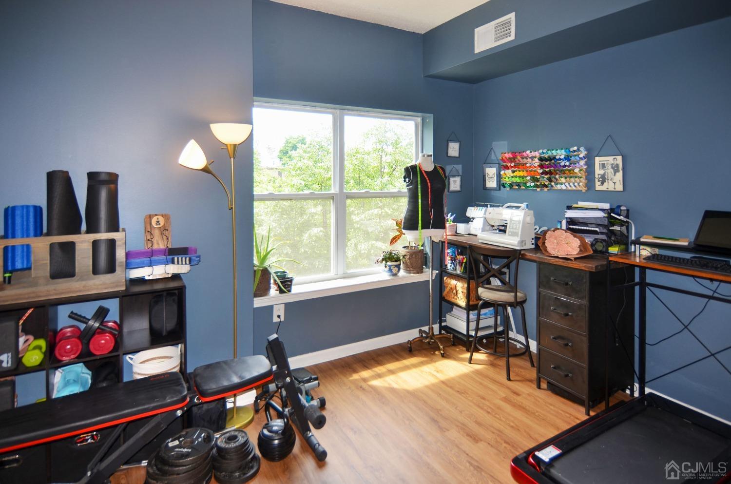 358 Rector Street, Unit 304 Perth Amboy, NJ 08861 - Photo 9 of 28 a view of a workspace with furniture and a window