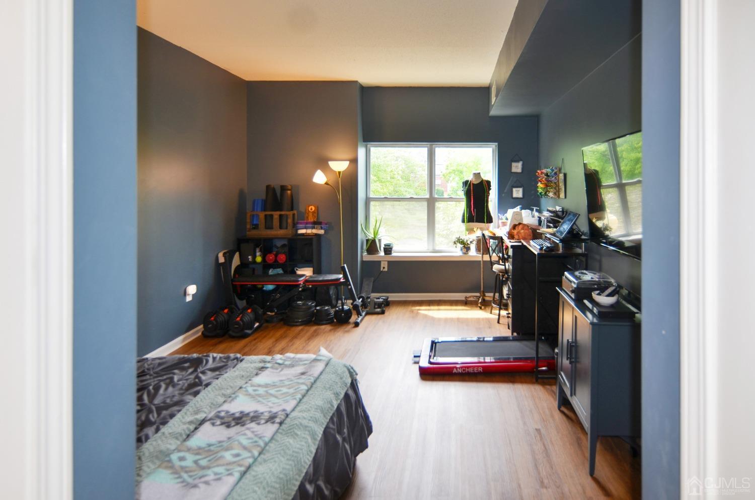 358 Rector Street, Unit 304 Perth Amboy, NJ 08861 - Photo 10 of 28 a view of a room with gym equipment and a large window