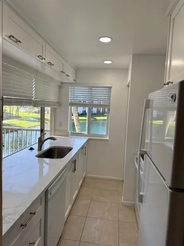 a white refrigerator freezer and a stove sitting inside of a kitchen