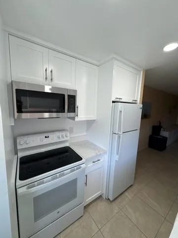 a bedroom with a bed and a lamp