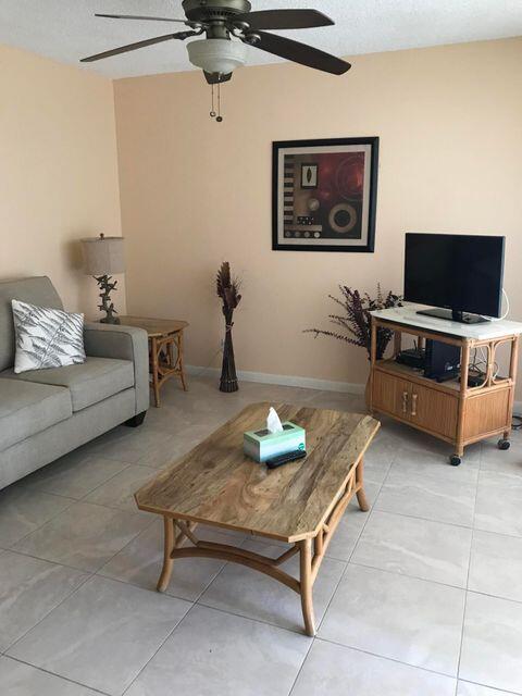 353 Highway 1, Unit A203 Jupiter, FL 33477 - Photo 7 of 26 a living room with furniture and a flat screen tv