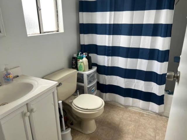 900 East Rankin Road, Unit 5 Tulare, CA 93274 - Photo 12 of 26 a white toilet sitting next to a sink and a shower curtain