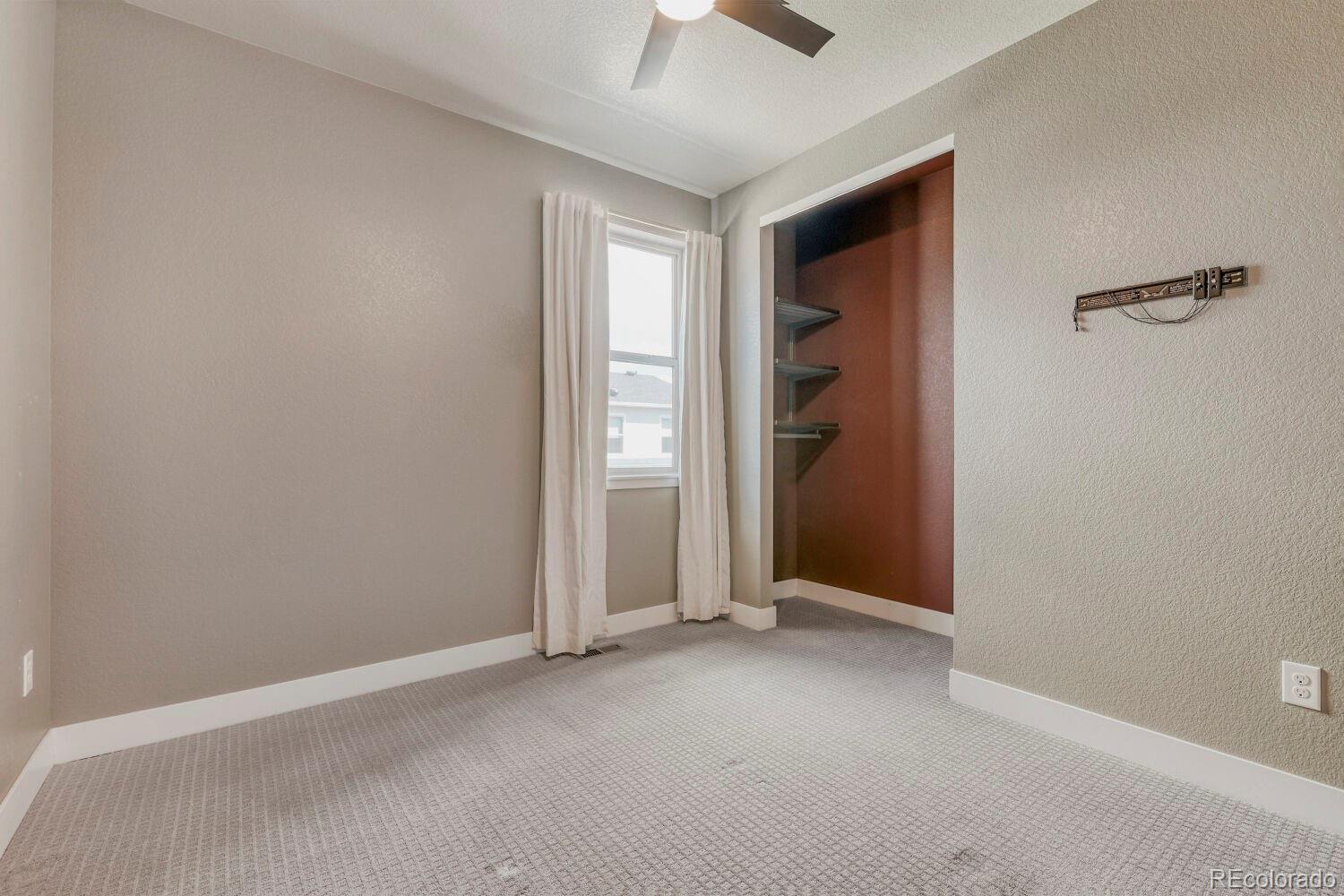6850 Decatur Street Denver, CO 80221 - Photo 23 of 30 a view of an empty room with a ceiling fan