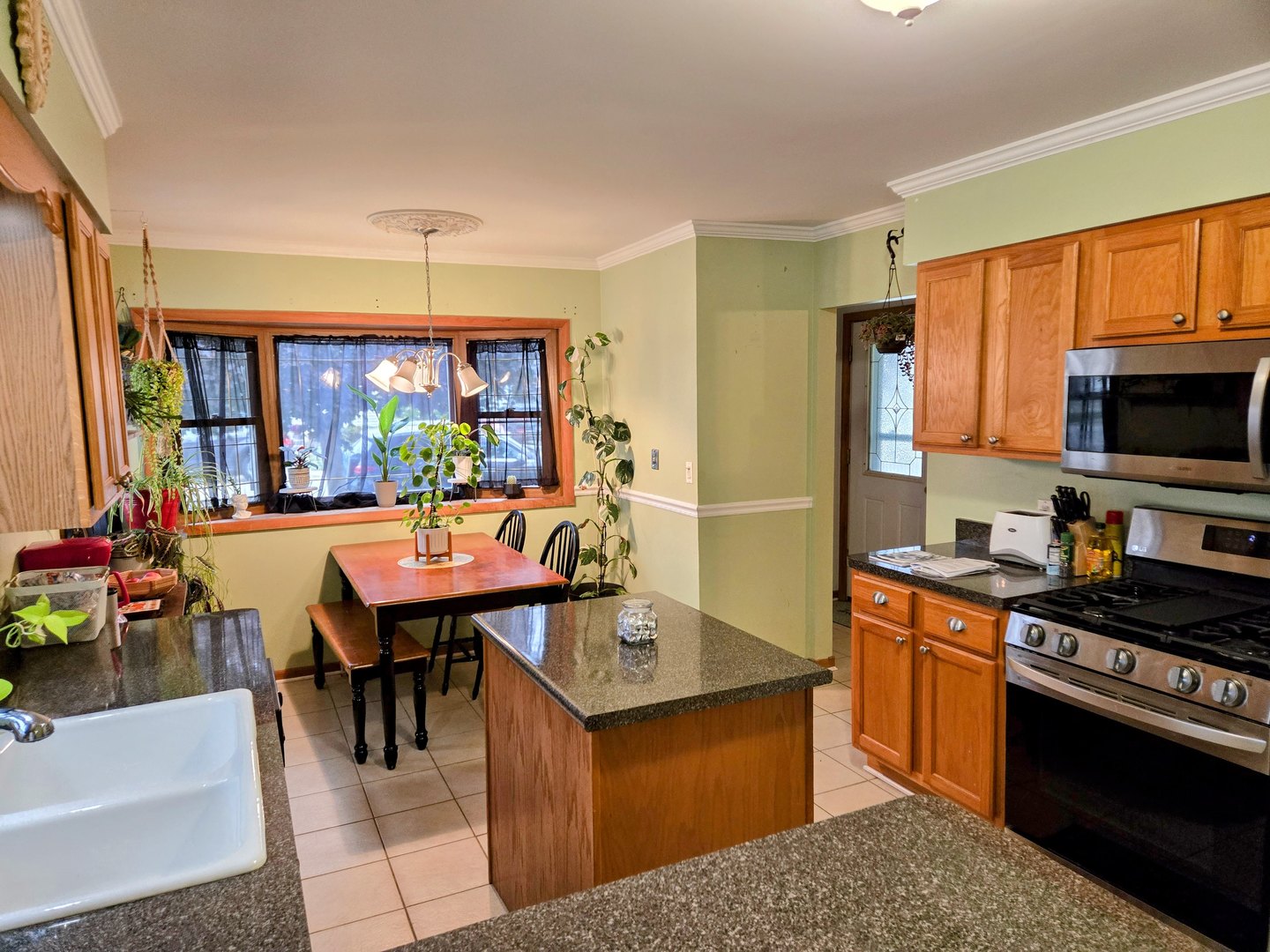 32 North Walnut Street Manteno, IL 60950 - Photo 4 of 11 a kitchen with stainless steel appliances granite countertop a stove refrigerator and a dining table