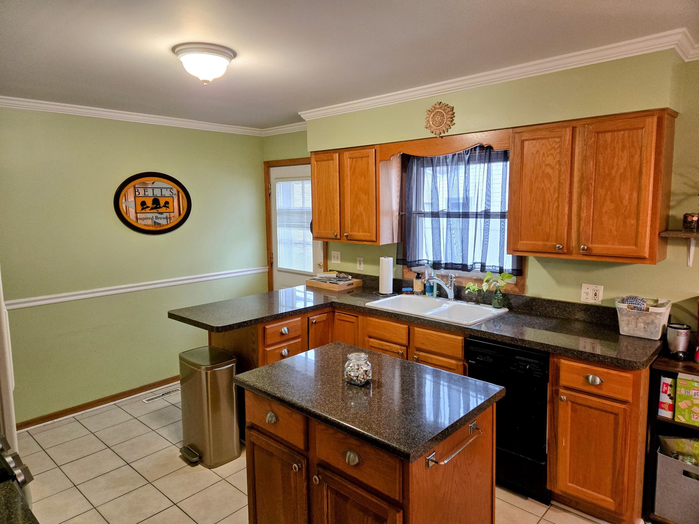 32 North Walnut Street Manteno, IL 60950 - Photo 5 of 11 a kitchen with a sink a stove and a window