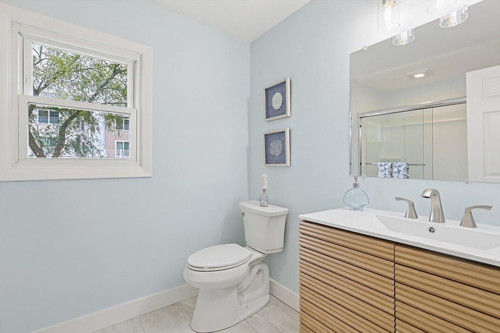 24 Otis Road Barnstable, MA 02601 - Photo 15 of 33 a bathroom with a sink a toilet and a window