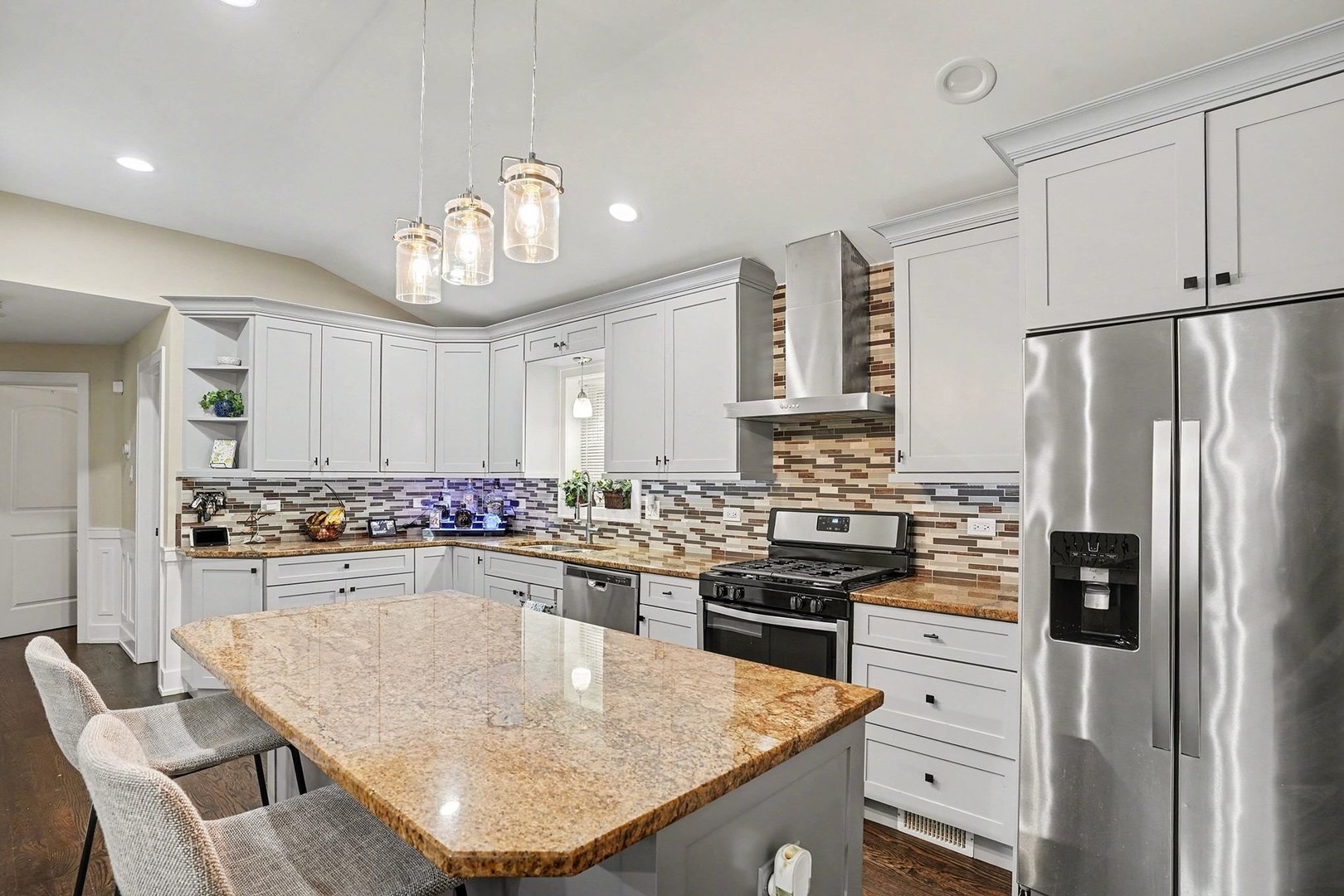 8953 South Aberdeen Street Chicago, IL 60620 - Photo 7 of 25 a kitchen with kitchen island a stove a chandelier and a refrigerator