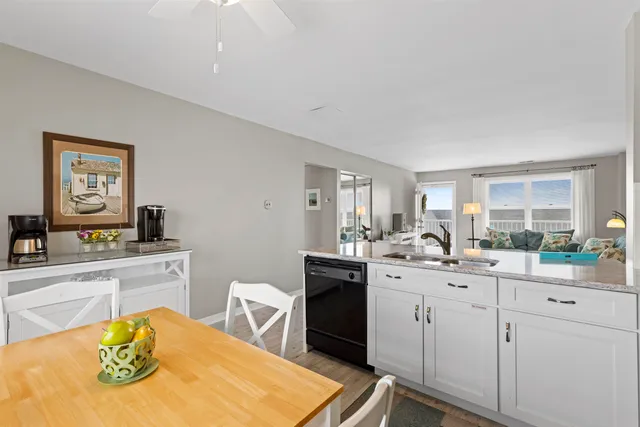 a view of a dining room with a table and chairs