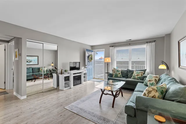 a kitchen with stainless steel appliances granite countertop a sink a stove a refrigerator a microwave oven with a dining table and chairs