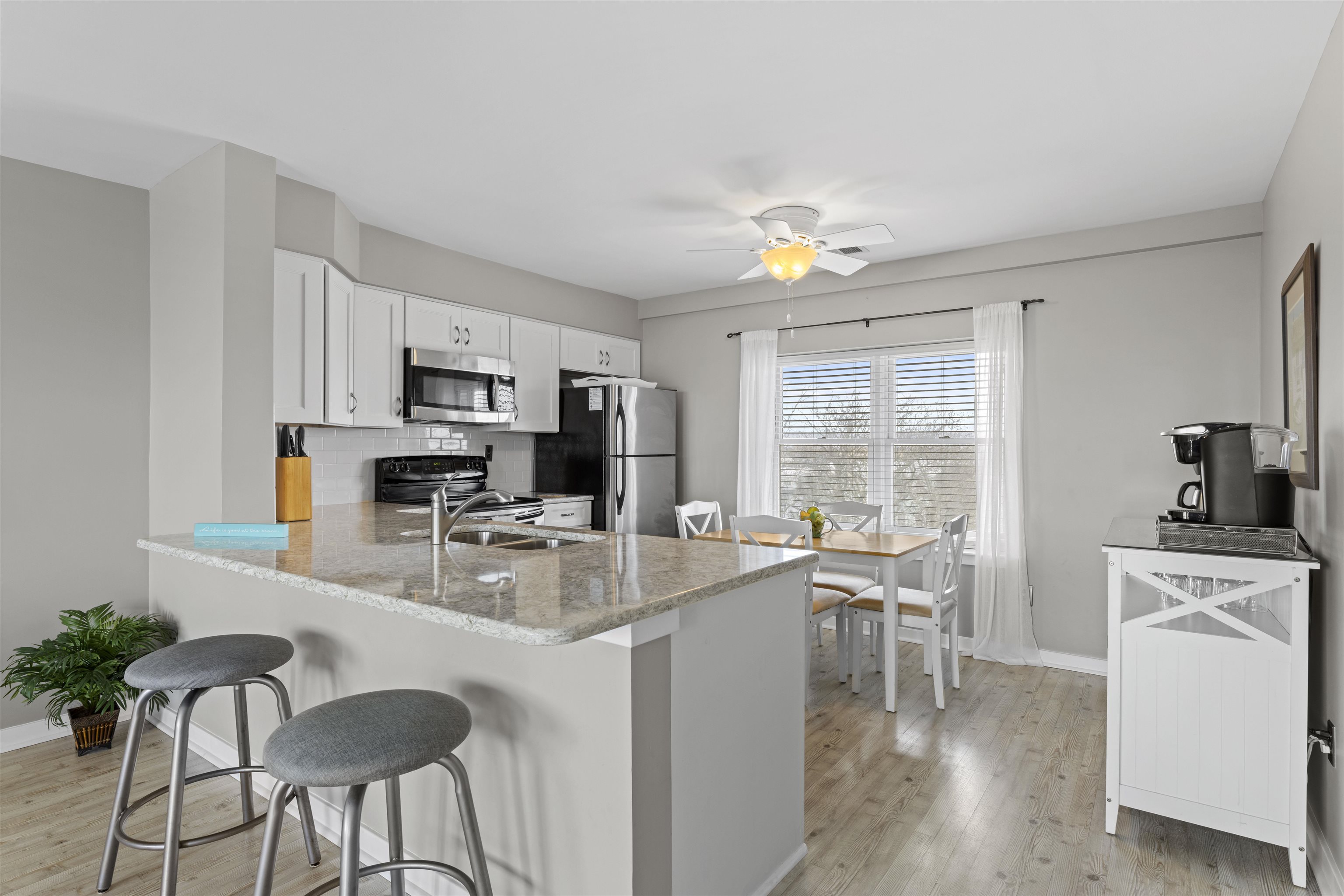 9 Jackson Street, Unit 506 Cape May, NJ 08204 - Photo 10 of 29 a very nice looking dining room with kitchen island granite countertop furniture a large window and a sink