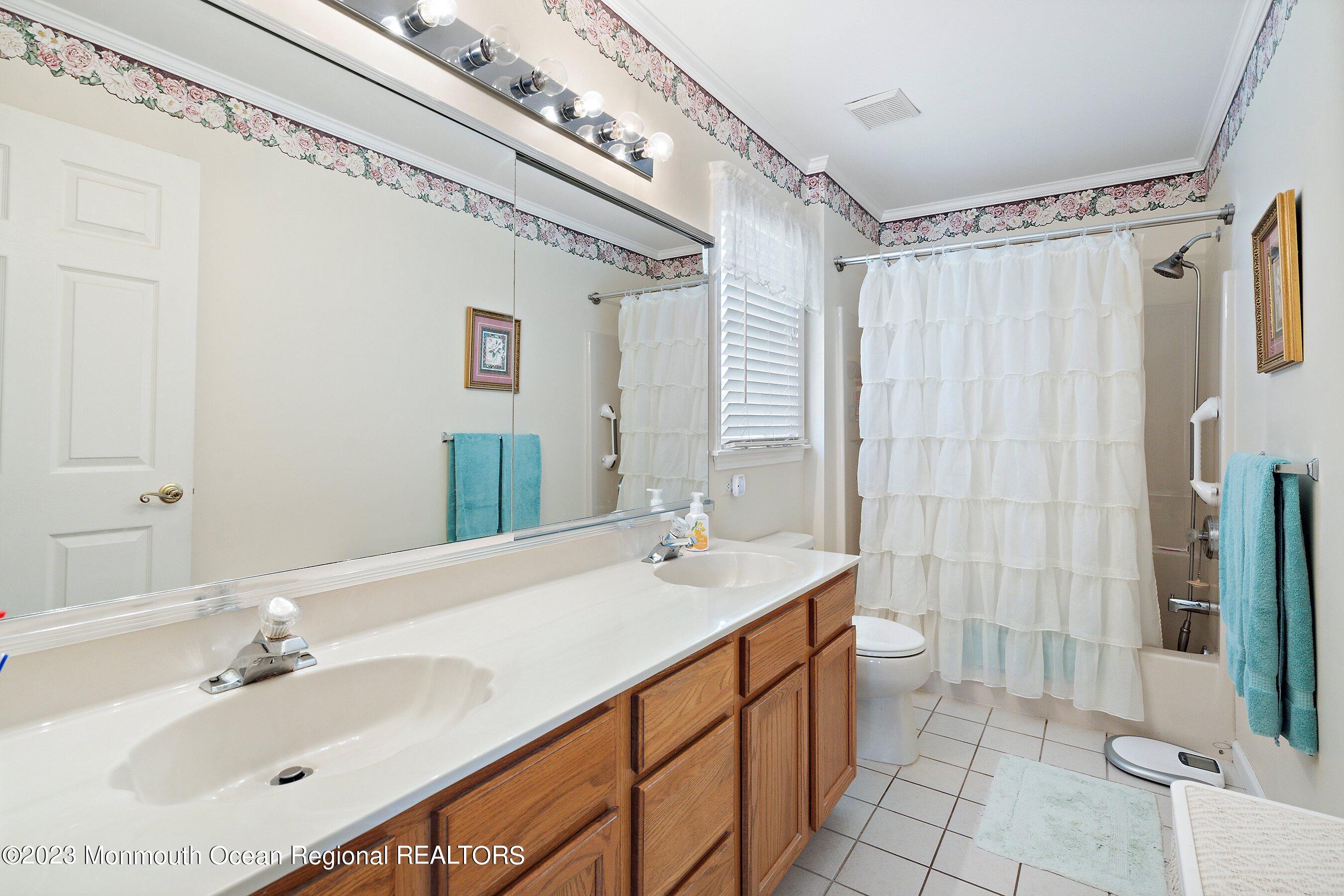 312 Leeward Road Manahawkin, NJ 08050 - Photo 18 of 25 a bathroom with a sink double vanity and a mirror