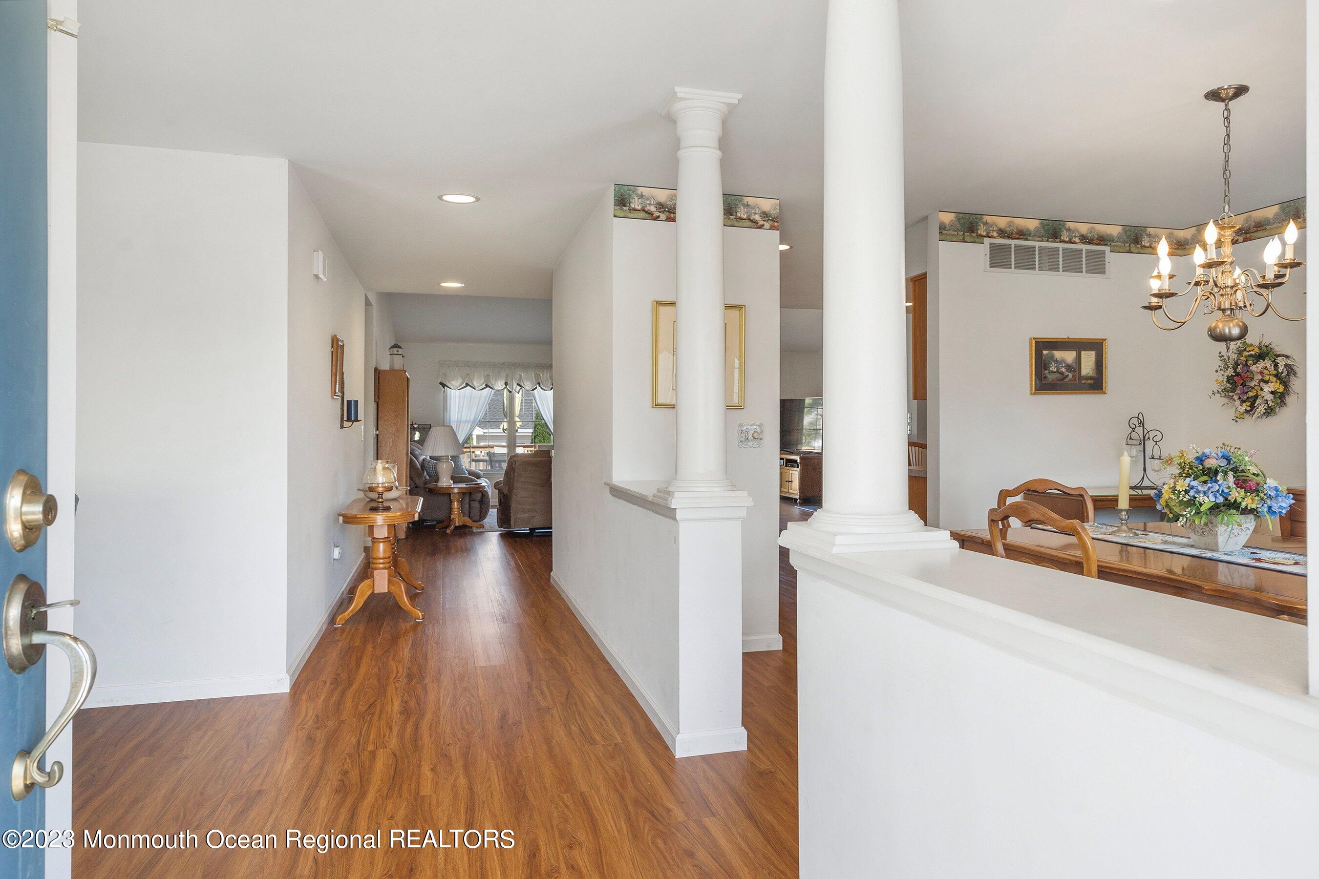 312 Leeward Road Manahawkin, NJ 08050 - Photo 3 of 25 a hallway with a sink and a wooden floor