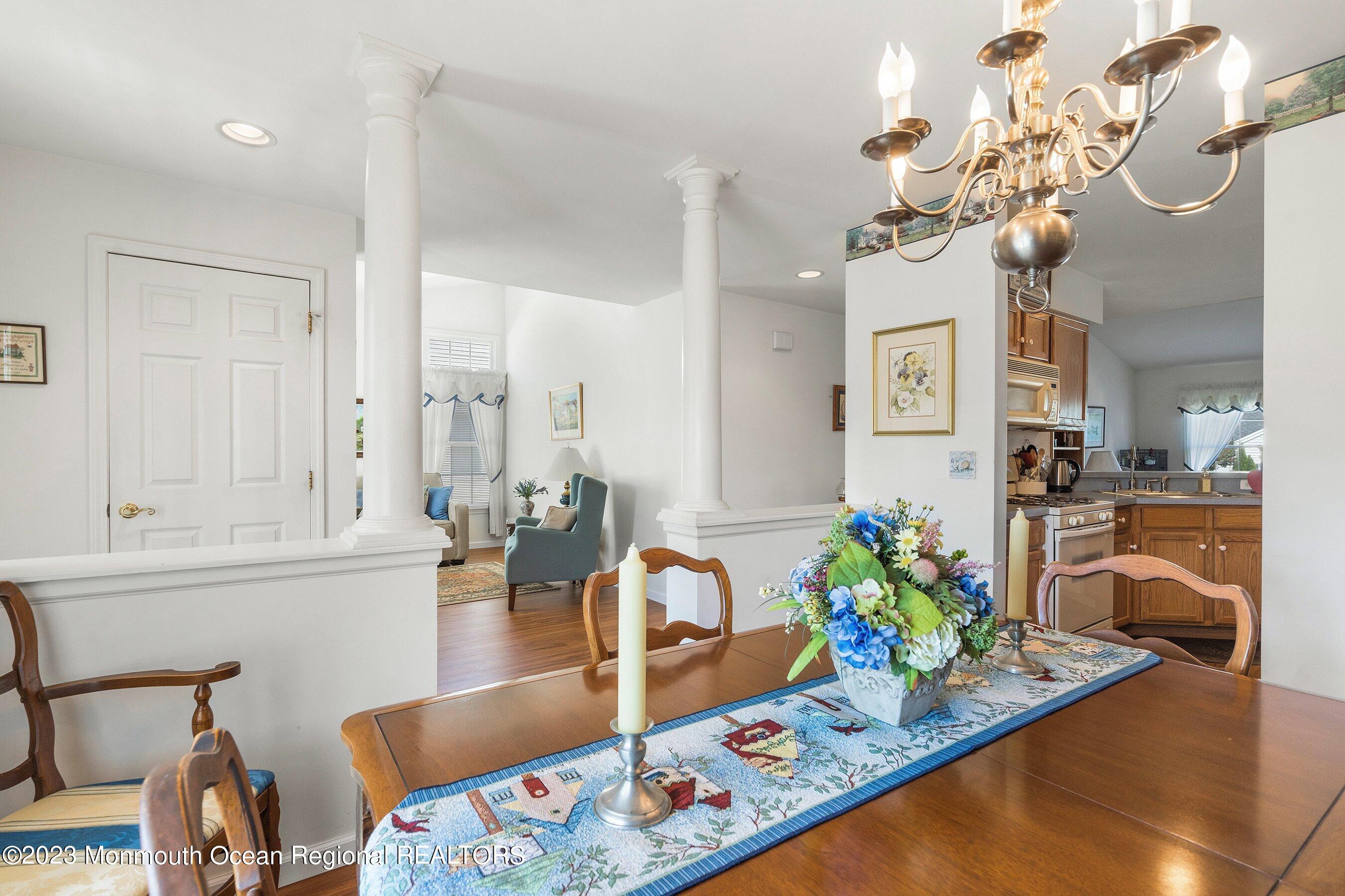 312 Leeward Road Manahawkin, NJ 08050 - Photo 5 of 25 a living room with dining table furniture and a chandelier