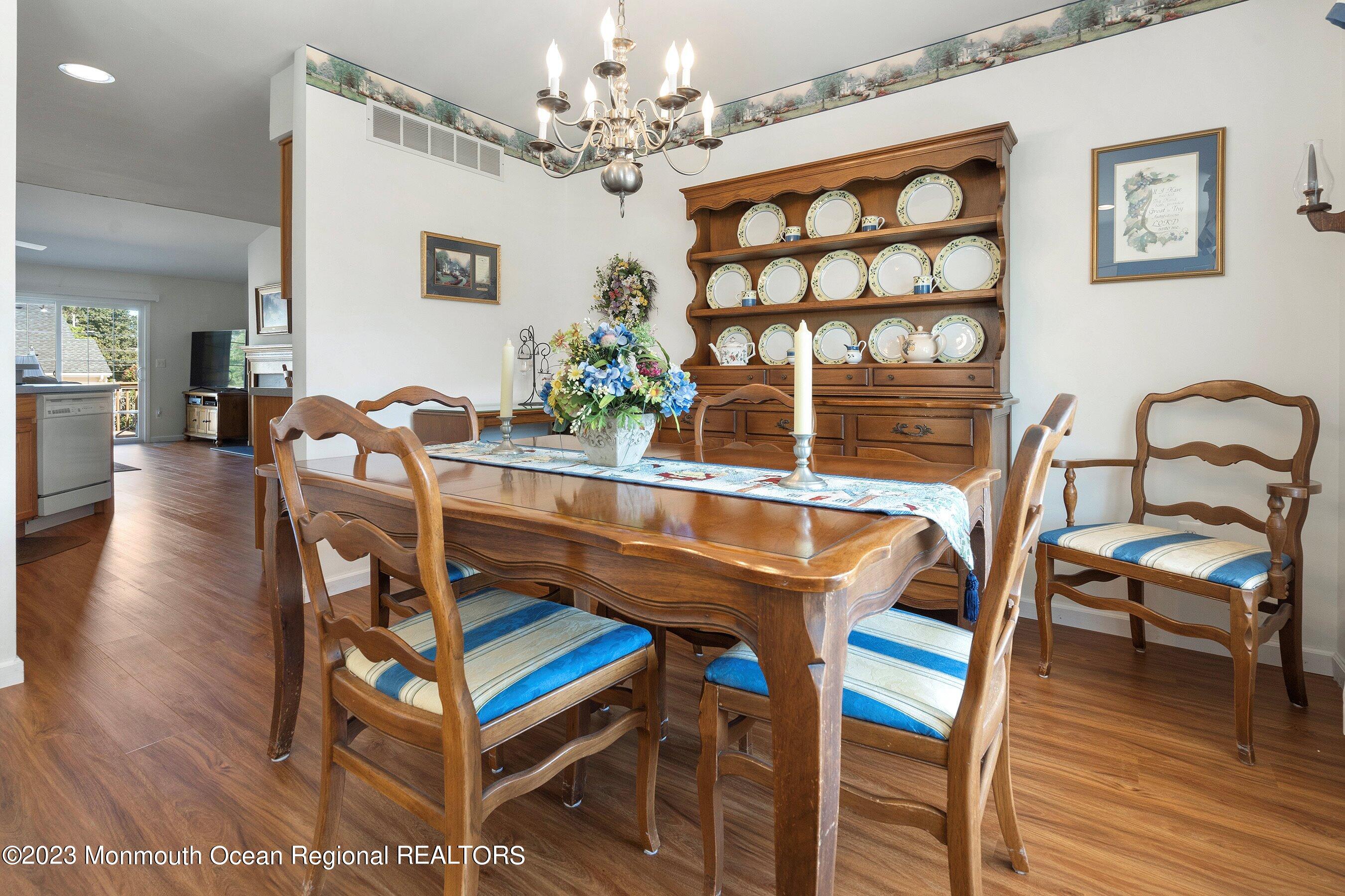 312 Leeward Road Manahawkin, NJ 08050 - Photo 6 of 25 a dining room with furniture a chandelier and wooden floor