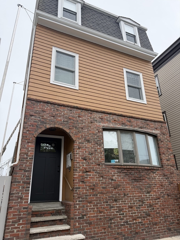 26 Brooks Street, Unit 2 Boston, MA 02128 - Photo 10 of 12 a building with a door and balcony